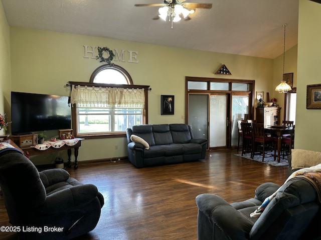 living room featuring lofted ceiling, dark hardwood / wood-style floors, and ceiling fan with notable chandelier