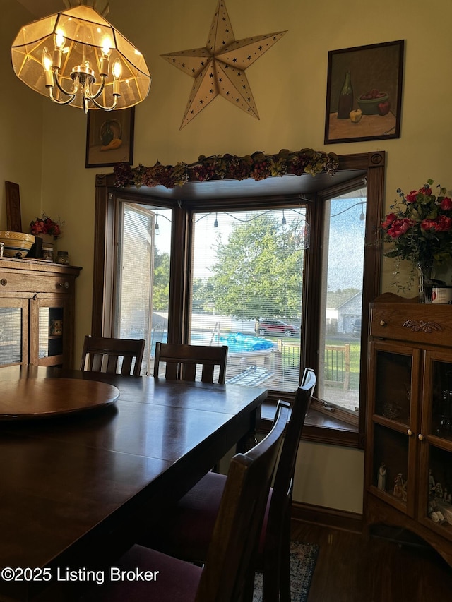 dining space featuring an inviting chandelier and dark hardwood / wood-style flooring