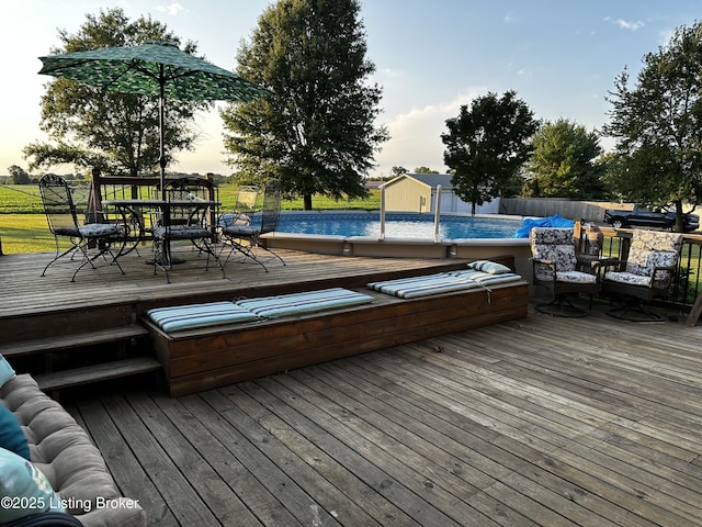 deck at dusk featuring a jacuzzi