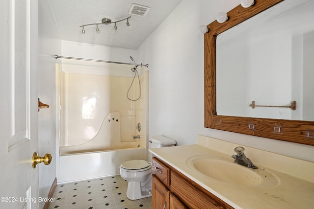 full bathroom featuring vanity, a textured ceiling, toilet, and  shower combination