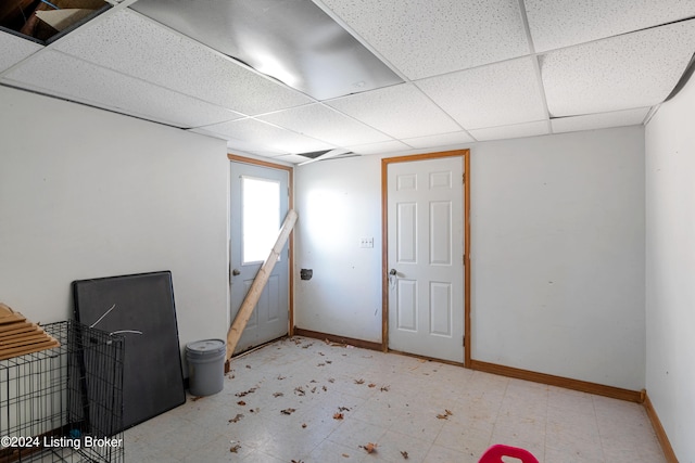 basement featuring a paneled ceiling