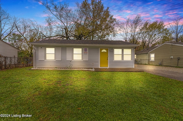 ranch-style house with a lawn