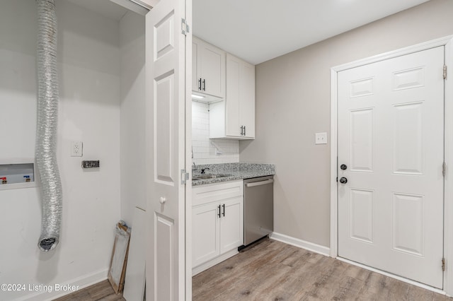 interior space with hookup for a washing machine, light hardwood / wood-style floors, and sink