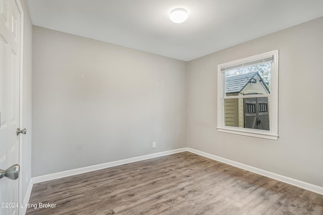 unfurnished room with hardwood / wood-style floors