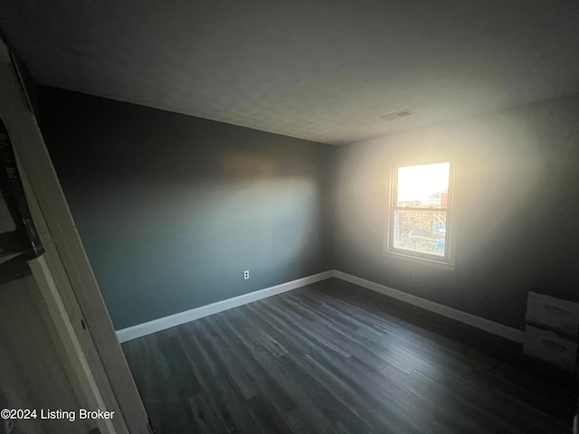 unfurnished room featuring dark hardwood / wood-style floors