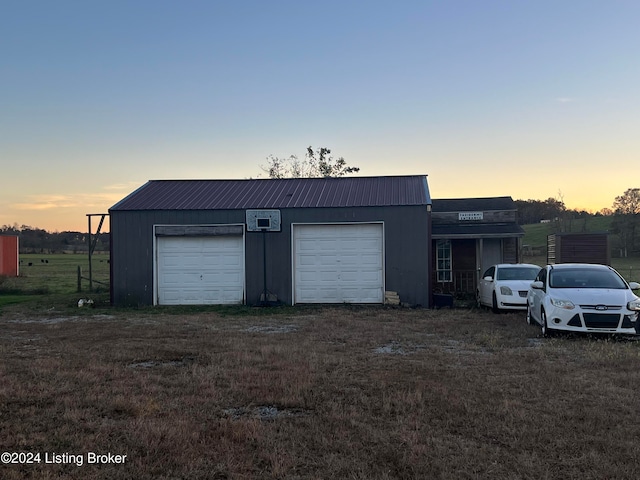 view of garage at dusk