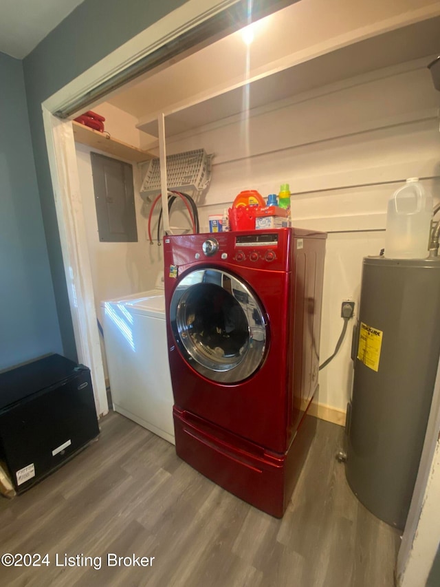 laundry room with electric panel, wood-type flooring, electric water heater, and separate washer and dryer