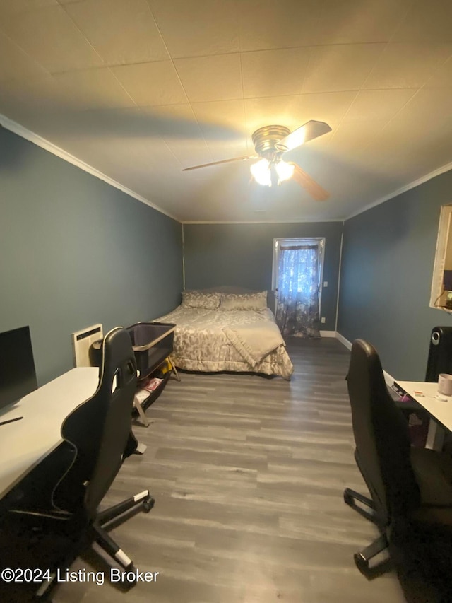 bedroom featuring ornamental molding, hardwood / wood-style flooring, and ceiling fan