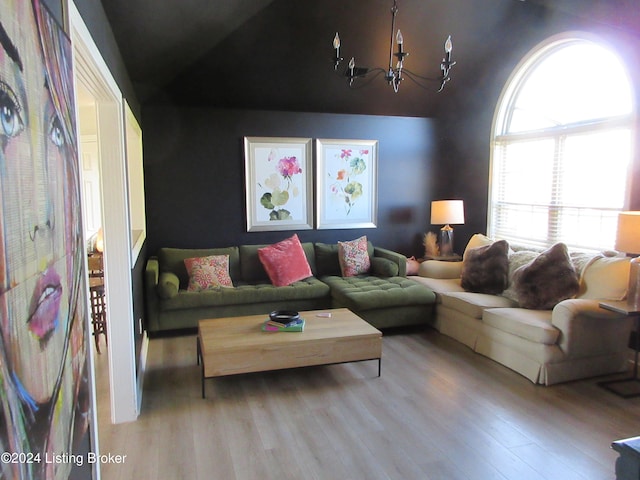 living room featuring vaulted ceiling and light hardwood / wood-style floors