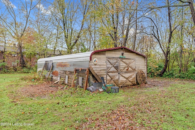 view of outbuilding featuring a yard