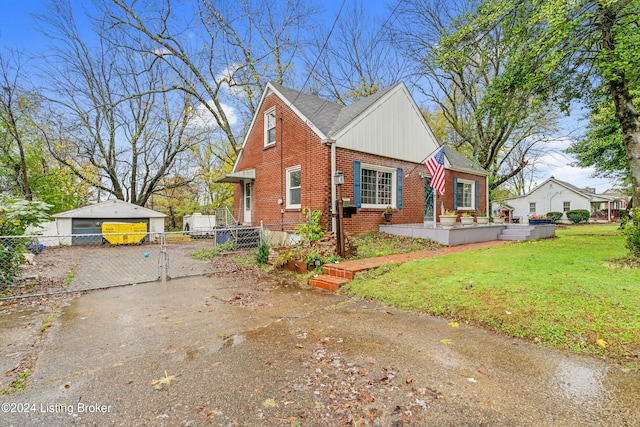 exterior space featuring a lawn, an outdoor structure, and a garage