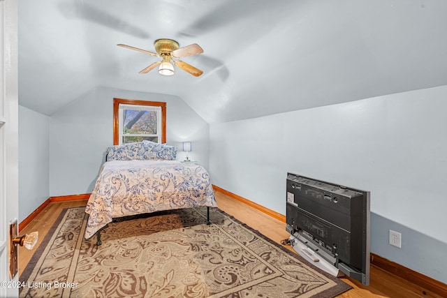 bedroom featuring hardwood / wood-style flooring, ceiling fan, and lofted ceiling