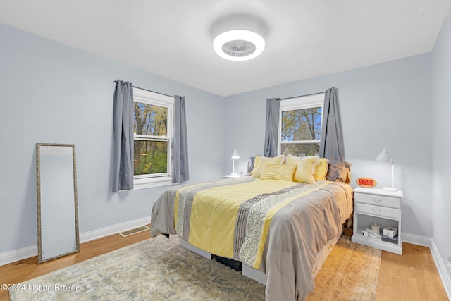 bedroom with hardwood / wood-style flooring