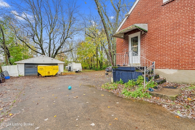 view of yard with a garage and an outbuilding