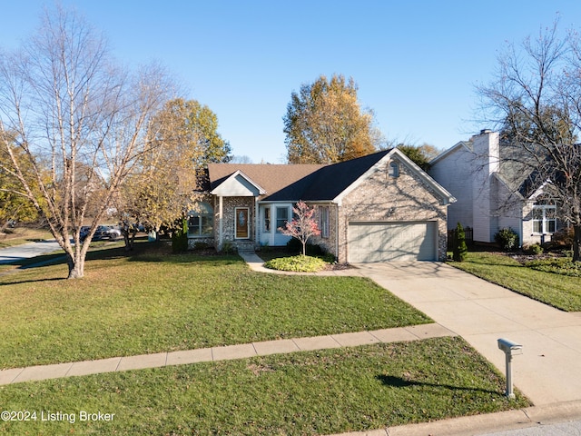 view of front facade with a front yard and a garage