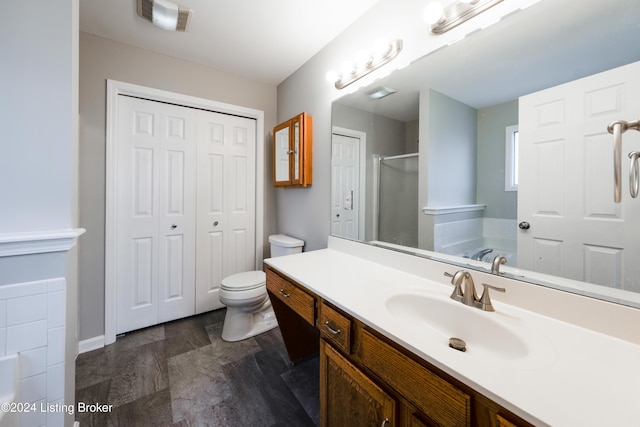 full bathroom with separate shower and tub, vanity, and toilet