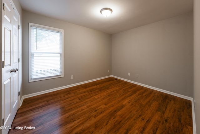 empty room featuring dark hardwood / wood-style flooring