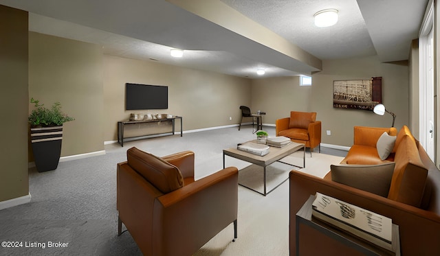 carpeted living room featuring a textured ceiling