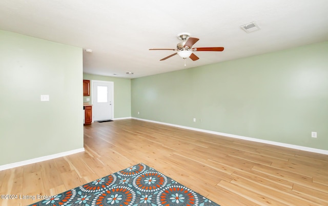 spare room with ceiling fan and wood-type flooring