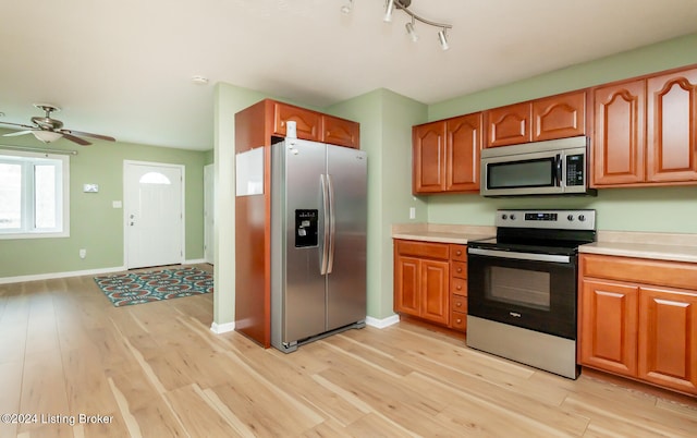 kitchen featuring ceiling fan, light hardwood / wood-style floors, and appliances with stainless steel finishes