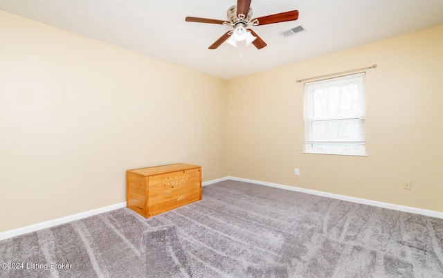 unfurnished room featuring ceiling fan and carpet floors