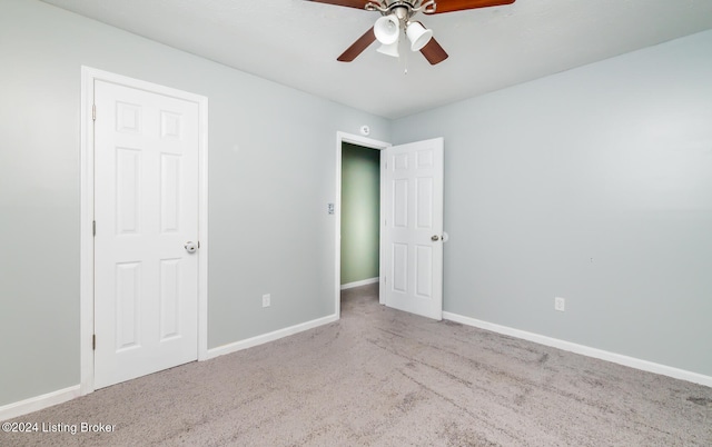 unfurnished bedroom featuring ceiling fan and light carpet