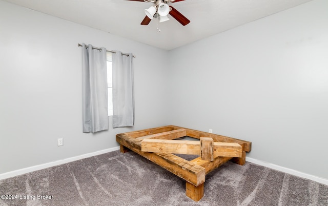 bedroom with dark colored carpet and ceiling fan