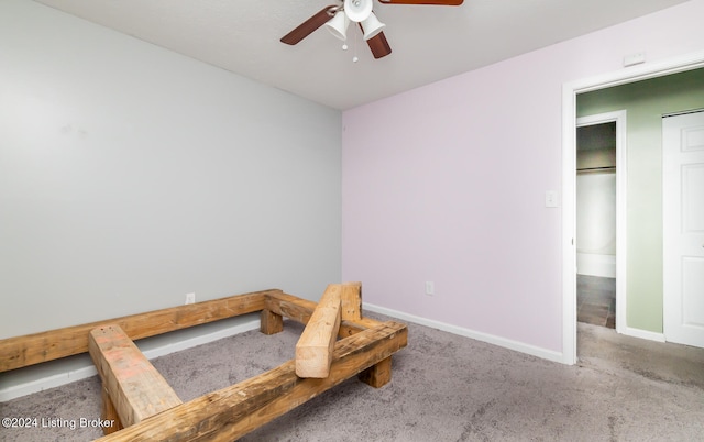 sitting room with ceiling fan and carpet floors