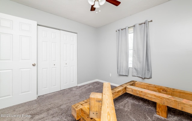 carpeted bedroom with ceiling fan and a closet