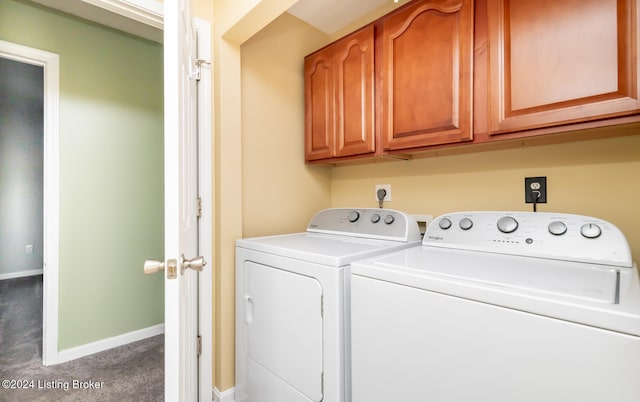 clothes washing area featuring washer and dryer, carpet flooring, and cabinets