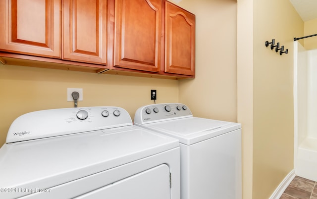 washroom featuring tile patterned floors, washer and clothes dryer, and cabinets