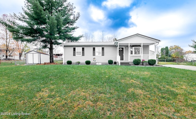 view of front of home with a porch, a storage shed, and a front yard