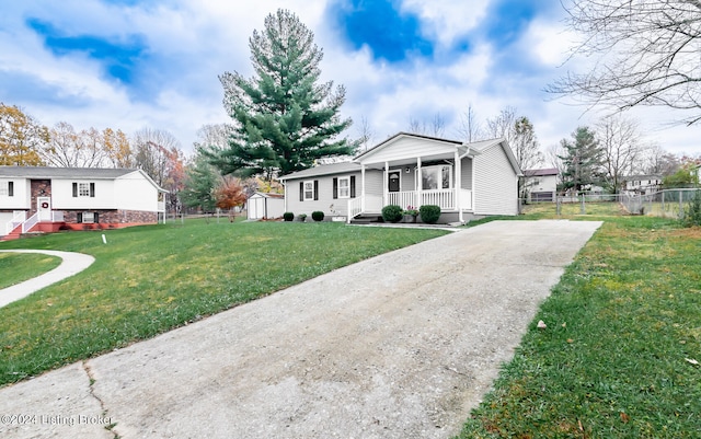 view of front facade with a front lawn, a porch, and a storage unit