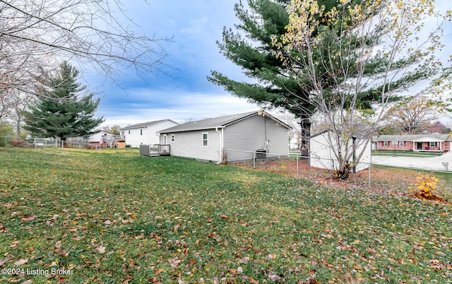 view of property exterior featuring a yard and a deck