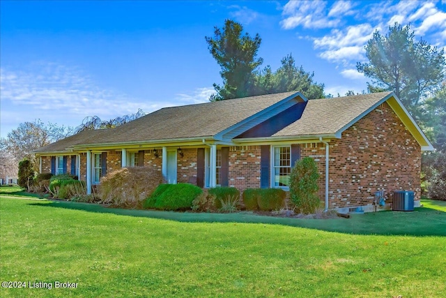 ranch-style home with a front yard and central AC