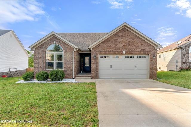 view of front facade with a front yard and a garage