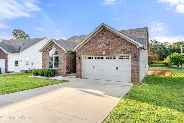 view of front of property featuring a garage and a front yard