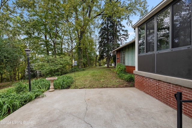 view of patio / terrace featuring a sunroom