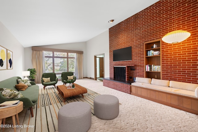 carpeted living room with vaulted ceiling, a brick fireplace, and brick wall