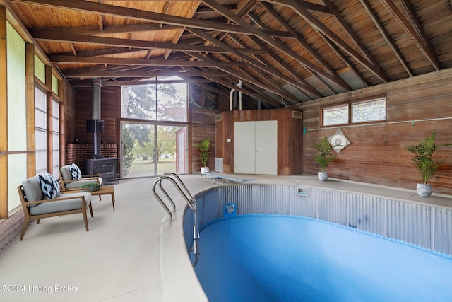 view of pool featuring a wood stove and a hot tub