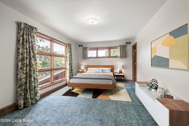 bedroom featuring carpet flooring and multiple windows