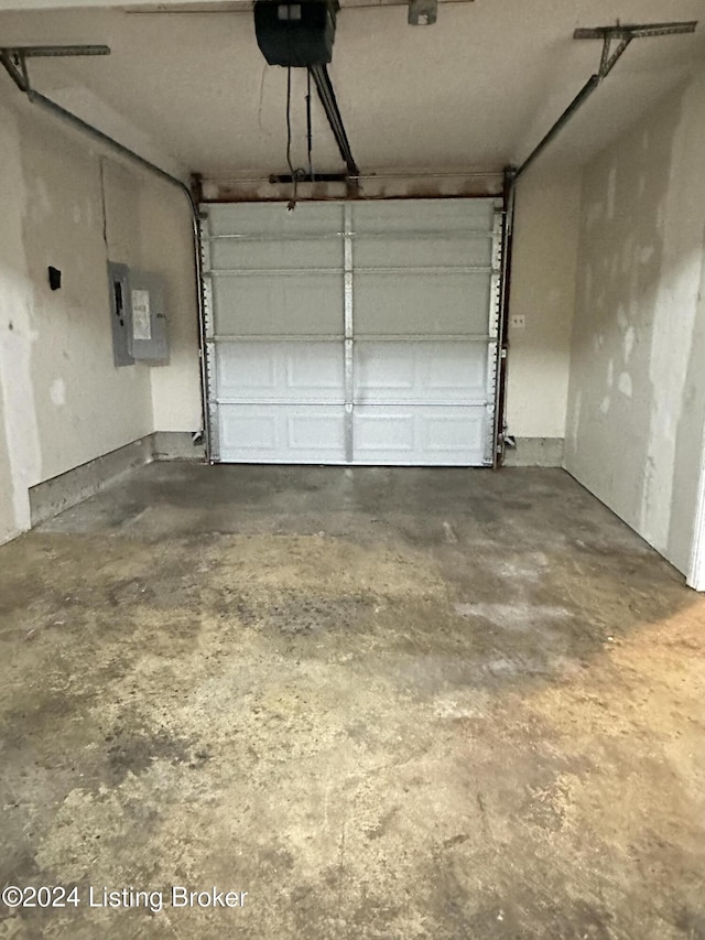 garage with electric panel and a garage door opener