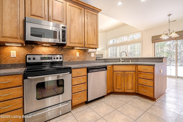 kitchen featuring sink, decorative backsplash, ornamental molding, and stainless steel appliances