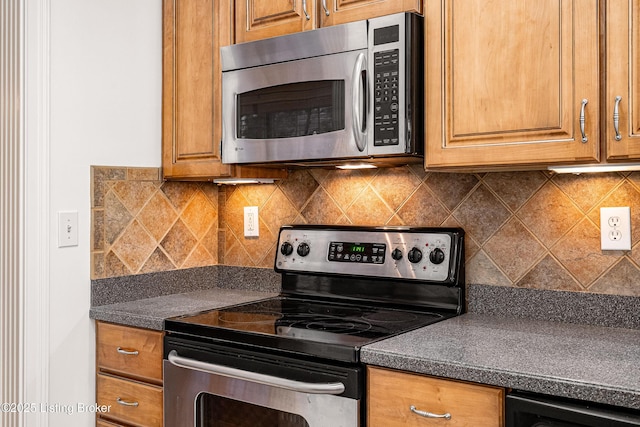 kitchen with stainless steel appliances and tasteful backsplash