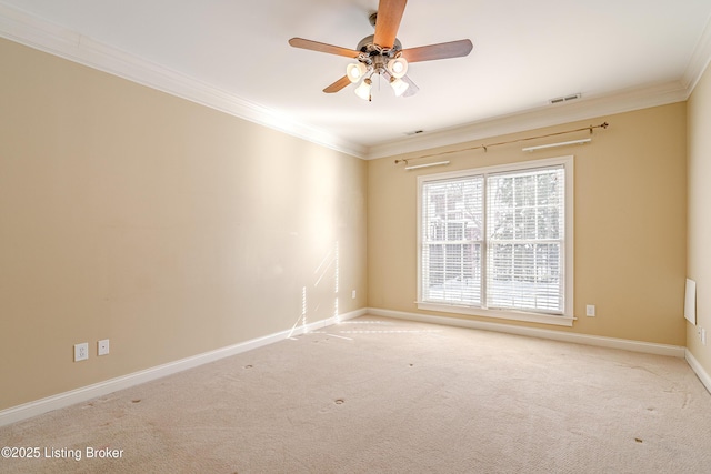 unfurnished room with ceiling fan, light carpet, and crown molding