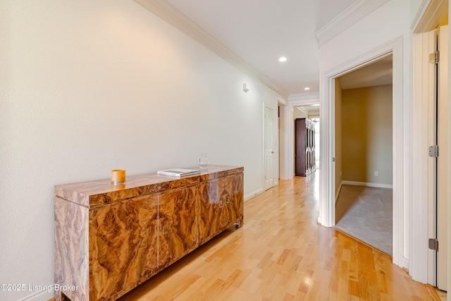 corridor with crown molding and light hardwood / wood-style floors