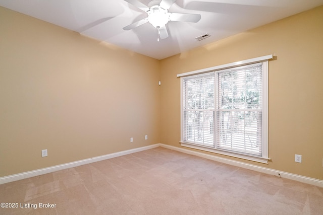 empty room with ceiling fan and light colored carpet