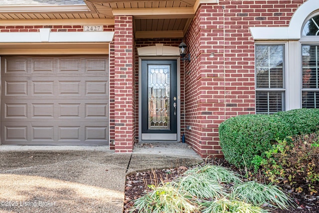 doorway to property with a garage