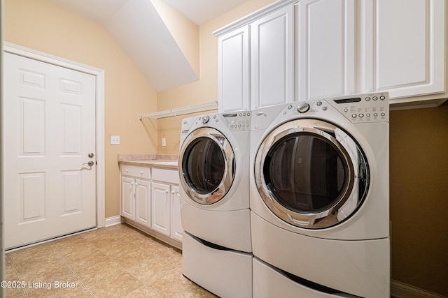 washroom featuring cabinets and washer and dryer