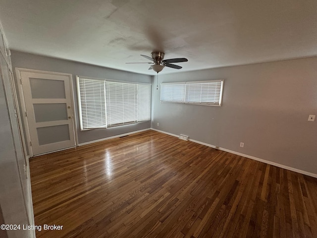 empty room featuring ceiling fan and dark hardwood / wood-style flooring